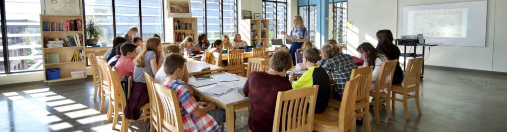 Salle de classe pleine d’élèves avec un enseignant en train d’enseigner